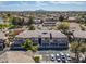 Aerial view showcasing the layout of the community with homes, mature trees, landscaping, and parking areas at 705 W Queen Creek Rd # 1201, Chandler, AZ 85248