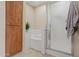 Bathroom with white bathtub, shower, and wooden storage cabinet at 705 W Queen Creek Rd # 1201, Chandler, AZ 85248