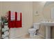 Bright bathroom with pedestal sink, tiled floor, and decorative towels and accents at 705 W Queen Creek Rd # 1201, Chandler, AZ 85248