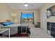 A carpeted bedroom with blue pillows and a window providing natural light and clear sky views at 705 W Queen Creek Rd # 1201, Chandler, AZ 85248
