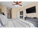 Open bedroom with neutral paint, ceiling fan, black dresser, and gray bedding at 705 W Queen Creek Rd # 1201, Chandler, AZ 85248