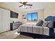 Bedroom with a TV, ceiling fan, neutral colors, and lots of natural light at 705 W Queen Creek Rd # 1201, Chandler, AZ 85248