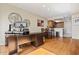 Open dining space with wood floors, leading into an adjacent kitchen area and home office at 705 W Queen Creek Rd # 1201, Chandler, AZ 85248