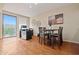 Contemporary dining area featuring wood flooring, a modern light fixture, and access to patio at 705 W Queen Creek Rd # 1201, Chandler, AZ 85248