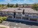 A high angle view shows a multi-unit home with a tile roof, garages, and surrounding trees at 705 W Queen Creek Rd # 1201, Chandler, AZ 85248