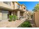 An exterior view of the complex, featuring desert landscaping and a private patio at 705 W Queen Creek Rd # 1201, Chandler, AZ 85248