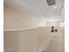 An empty carpeted hallway with neutral walls and recessed lighting, leading towards a window at 705 W Queen Creek Rd # 1201, Chandler, AZ 85248