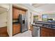 Efficient kitchen with wood cabinets, stainless steel appliances, and tiled floor at 705 W Queen Creek Rd # 1201, Chandler, AZ 85248
