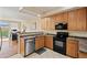 Functional kitchen with wood cabinets, stainless steel dishwasher, and open access to the dining area at 705 W Queen Creek Rd # 1201, Chandler, AZ 85248