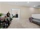 Open loft space with neutral walls, carpeting, and an inviting view through an open doorway at 705 W Queen Creek Rd # 1201, Chandler, AZ 85248