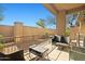 A well-furnished outdoor patio including a grill, couch and table, surrounded by desert landscaping at 705 W Queen Creek Rd # 1201, Chandler, AZ 85248