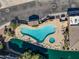 Aerial view of community pool, lounge chairs, landscaped pool, and views of the community waterway at 705 W Queen Creek Rd # 1201, Chandler, AZ 85248