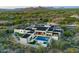 Breathtaking aerial view of a modern luxury home showcasing a pool, putting green, and lush desert surroundings at 7498 E Whisper Rock Trl, Scottsdale, AZ 85266