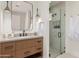 Contemporary bathroom with glass shower, hanging pendant light, and wooden vanity at 7498 E Whisper Rock Trl, Scottsdale, AZ 85266