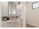 Modern bathroom featuring a marble countertop sink, elegant fixtures, and a sleek mirror at 7498 E Whisper Rock Trl, Scottsdale, AZ 85266