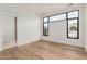 Bedroom with hardwood floors and a large window at 7498 E Whisper Rock Trl, Scottsdale, AZ 85266