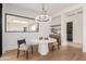 Elegant dining area with modern light fixture and a view to outdoor space through a glass window at 7498 E Whisper Rock Trl, Scottsdale, AZ 85266