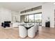 Open-concept dining area boasts hardwood floors, modern furnishings, and large windows with natural light at 7498 E Whisper Rock Trl, Scottsdale, AZ 85266