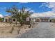 Stunning desert home featuring stone accents, a paver driveway, and beautiful desert landscaping with cacti at 7498 E Whisper Rock Trl, Scottsdale, AZ 85266