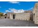 Beautiful exterior stone wall with a paver driveway in a stunning architectural design at 7498 E Whisper Rock Trl, Scottsdale, AZ 85266