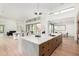 Bright, open kitchen featuring a large island with seating and modern lighting, adjacent to dining and living areas at 7498 E Whisper Rock Trl, Scottsdale, AZ 85266