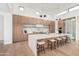 Modern kitchen with center island and barstool seating featuring wood cabinetry, stainless steel appliances, and contemporary lighting at 7498 E Whisper Rock Trl, Scottsdale, AZ 85266