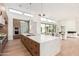 Modern kitchen boasts hardwood floors, an island with a stone countertop, and an open layout at 7498 E Whisper Rock Trl, Scottsdale, AZ 85266