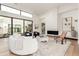 Spacious living room with hardwood floors, modern furnishings, and a cozy fireplace at 7498 E Whisper Rock Trl, Scottsdale, AZ 85266