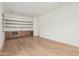 Open living area with a bar, shelving, and light hardwood floors at 7498 E Whisper Rock Trl, Scottsdale, AZ 85266