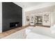Luxurious main bedroom suite with modern fireplace, hardwood floors, and an open layout at 7498 E Whisper Rock Trl, Scottsdale, AZ 85266