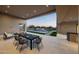 Elegant outdoor dining area overlooking a shimmering pool and fire pit, perfect for entertaining guests in style at 7498 E Whisper Rock Trl, Scottsdale, AZ 85266