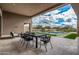 Outdoor dining area featuring a table, a view of the pool, and manicured landscaping at 7498 E Whisper Rock Trl, Scottsdale, AZ 85266
