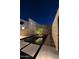 Tranquil outdoor space with a water feature, illuminated tree, and contemporary design elements under a starry night sky at 7498 E Whisper Rock Trl, Scottsdale, AZ 85266