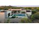 Stylish modern home boasts a luxurious pool and spa with a fire pit, perfect for outdoor relaxation and entertaining at 7498 E Whisper Rock Trl, Scottsdale, AZ 85266