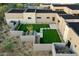 Aerial view of a modern home with a putting green, offering a unique recreational space and elegant design at 7498 E Whisper Rock Trl, Scottsdale, AZ 85266