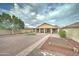 Wide backyard featuring a covered patio, gravel landscaping, stone path, and garden beds at 7822 S 15Th Way, Phoenix, AZ 85042