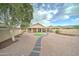 Spacious backyard with a covered patio, gravel landscaping, and a stone pathway at 7822 S 15Th Way, Phoenix, AZ 85042