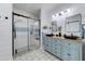 Stylish bathroom with double vanity, modern mirrors, beautiful tile flooring, and glass enclosed shower at 7822 S 15Th Way, Phoenix, AZ 85042