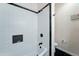 A minimalist bathroom featuring subway tiles and black hardware at 7822 S 15Th Way, Phoenix, AZ 85042