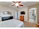 Spacious bedroom featuring a ceiling fan, dressers, and an ensuite bathroom at 7822 S 15Th Way, Phoenix, AZ 85042