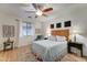 Comfortable bedroom with ceiling fan, stylish rug, and decorative side tables with lamps at 7822 S 15Th Way, Phoenix, AZ 85042