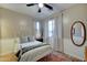 A cozy bedroom with natural light, white-painted bed, and hardwood floors at 7822 S 15Th Way, Phoenix, AZ 85042