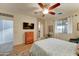 Inviting bedroom showcases an ensuite bathroom, ceiling fan, and bright natural light at 7822 S 15Th Way, Phoenix, AZ 85042