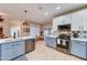 A modern kitchen with stainless steel appliances, blue cabinets, and an island at 7822 S 15Th Way, Phoenix, AZ 85042