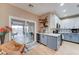 Modern kitchen boasts stainless appliances, stylish backsplash, breakfast bar and sliding glass doors to covered patio at 7822 S 15Th Way, Phoenix, AZ 85042