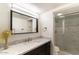 Modern bathroom with marble vanity, shower and dark wood cabinets at 7930 E Arlington Rd # 8, Scottsdale, AZ 85250