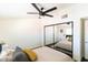 Bedroom features ceiling fan, hardwood floors, mirrored closet doors, and colorful pillows on the bed at 7930 E Arlington Rd # 8, Scottsdale, AZ 85250