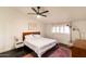 Comfortable bedroom with white linens, ceiling fan, and bright natural light at 7930 E Arlington Rd # 8, Scottsdale, AZ 85250