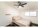 Bedroom features a ceiling fan, window, hardwood floors, and neutral bedding at 7930 E Arlington Rd # 8, Scottsdale, AZ 85250