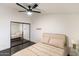 Bedroom with ceiling fan, hardwood floors, mirrored closet doors, and neutral bedding at 7930 E Arlington Rd # 8, Scottsdale, AZ 85250